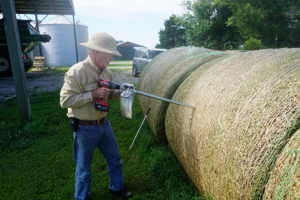 Farmer treating a bale of hay